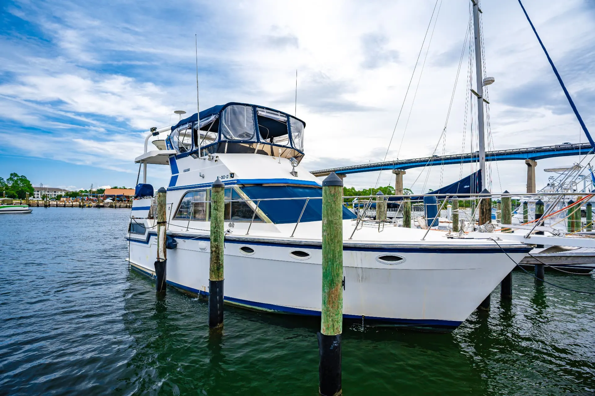 Trawler moored in a deepwater slip with the Perdido Key bridge behind