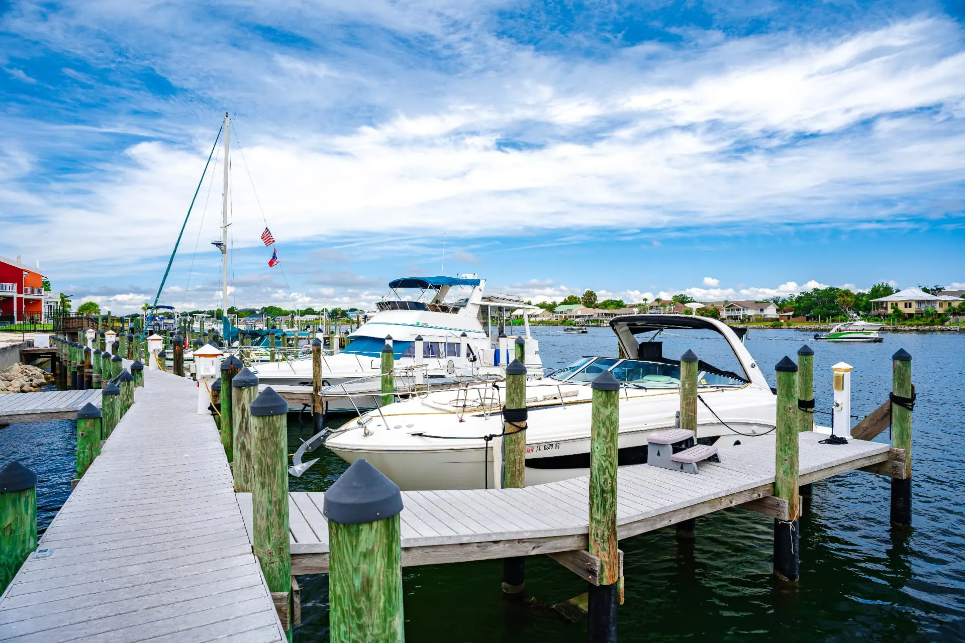 Deep water marina slips with boats docked along the pier at Perdido Key