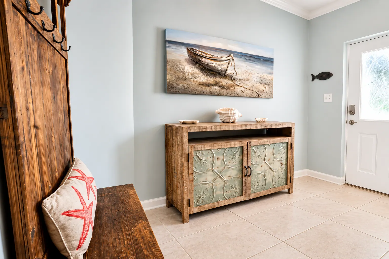 Condo entryway with rustic bench, console table, and coastal artwork