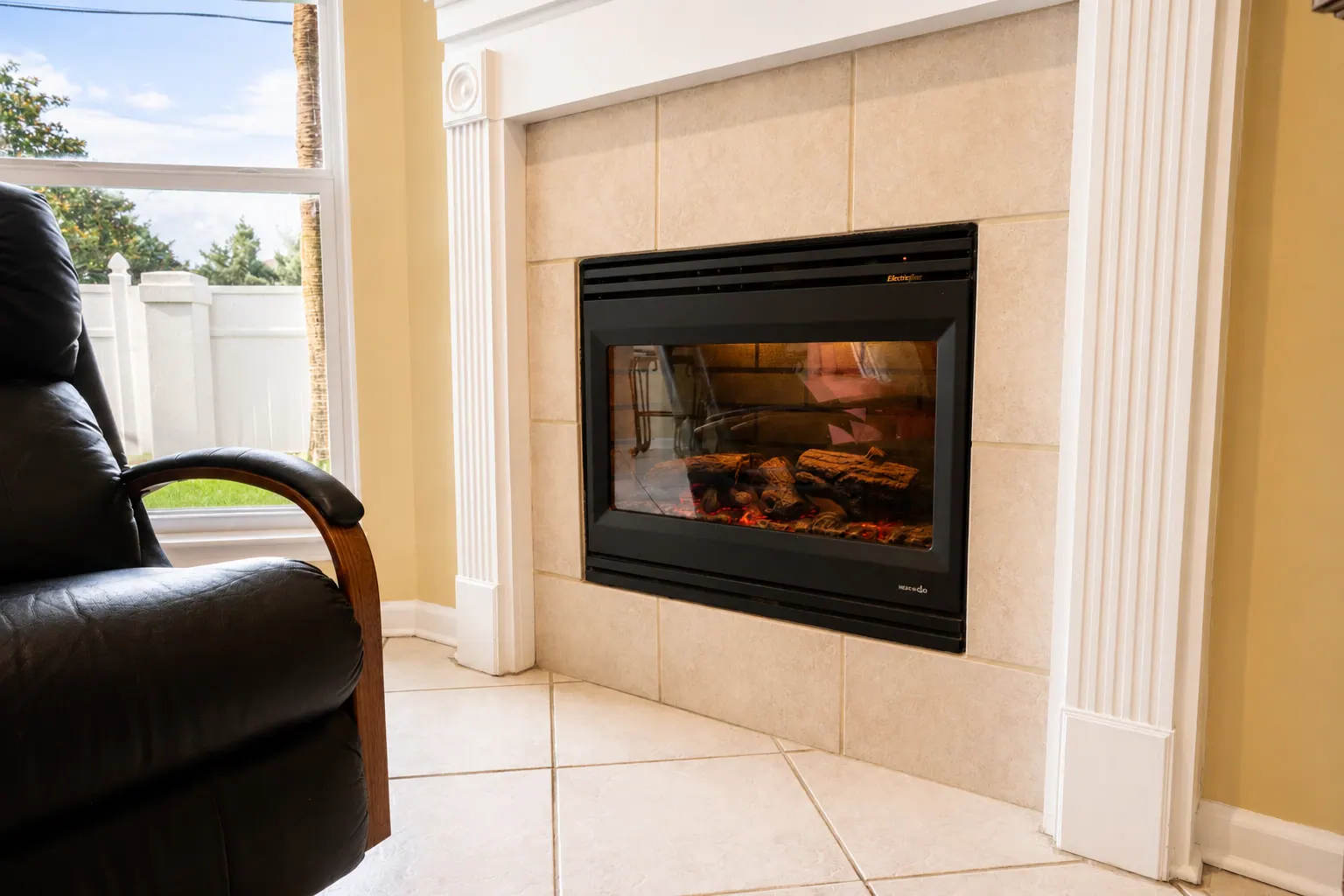 Electric fireplace and leather recliner in a furnished condo