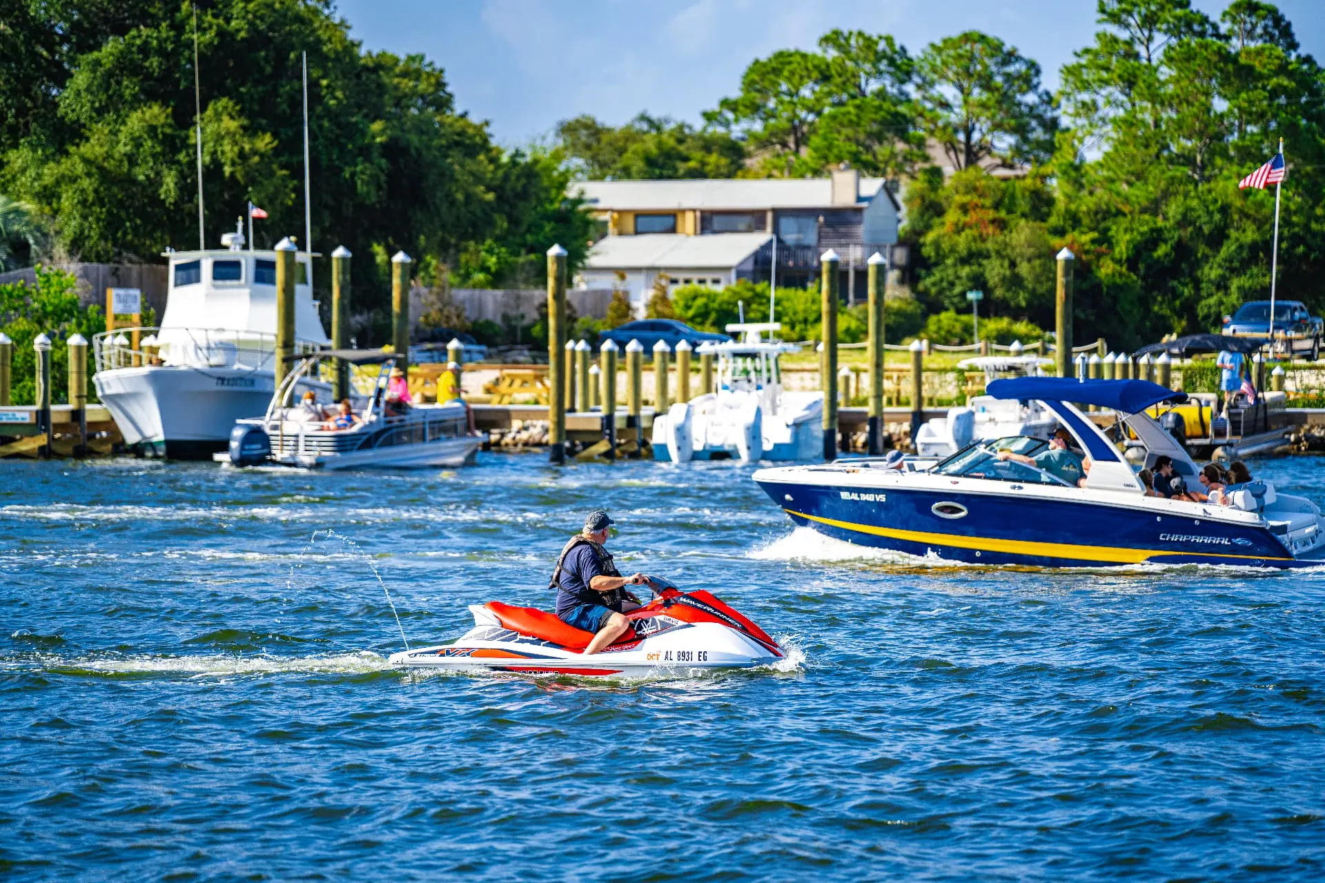 Jet ski and boats on the water near the marina