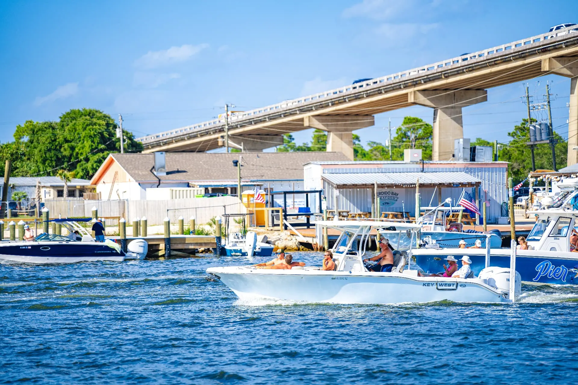 Boats cruising the Intracoastal Waterway beneath the Perdido Key bridge